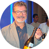 Image of a man holding a bottle of wine